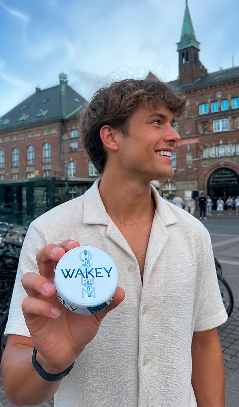 Man holding a Wakey Blizzard Mint tin in Copenhagen