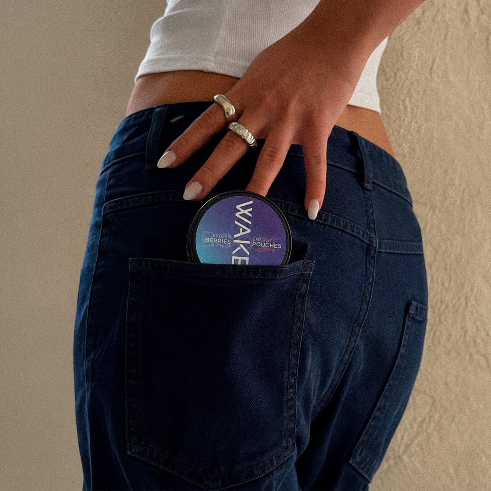 Wakey Frozen Berries tin tucked into a jeans pocket